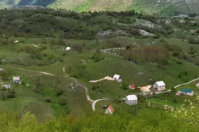Was ist denn das für eine verrückte Perspektive? Wie aus dem Flugzeug. Von der Straße aus schweift der Blick hinunter über eine hügelige Hochebene. Blick von oben auf ein kleines Dorf tief unten im Tal
